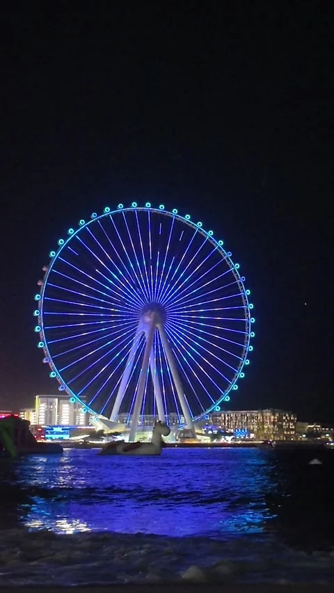 Dubai, UAE - May 24, 2026: Ain Dubai Ferris wheel illuminated at night, Blu.. Stock Footage 335550397