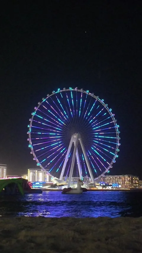 Dubai, UAE - May 24, 2026: Ain Dubai Ferris wheel illuminated at night, Blu.. Stock Footage 335550416