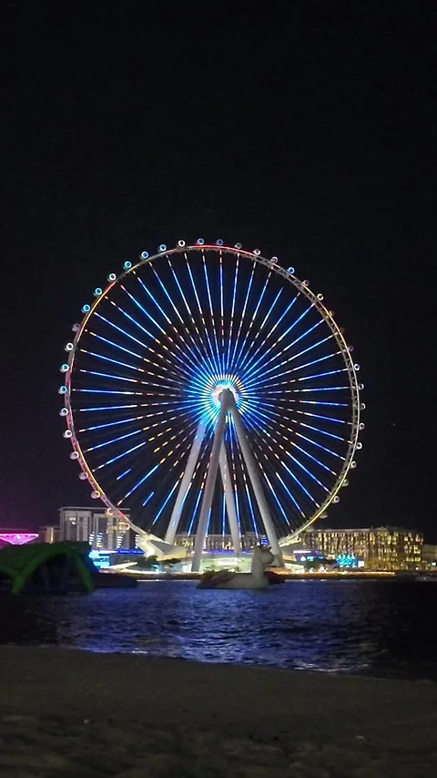 Dubai, UAE - May 24, 2026: Ain Dubai Ferris wheel illuminated at night, Blu.. Stock Footage 335550535
