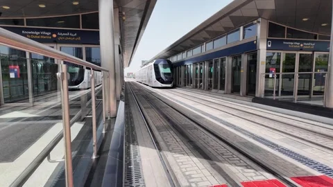 Dubai, UAE - May 26, 2026: Dubai Marina Tram passing through modern skyscra.. Stock Footage 335695008