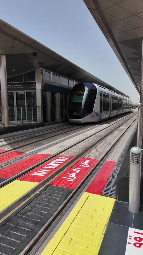 Dubai, UAE - May 26, 2026: Dubai Marina Tram passing through modern skyscra.. Stock Footage 335695106