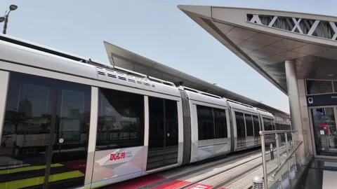 Dubai, UAE - May 26, 2026: Dubai Marina Tram passing through modern skyscra.. Stock Footage 335695265