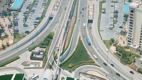 Dubai, UAE - May 5, 2024: Aerial view of car traffic in modern Arabic city, UAE Stock Footage 287609537