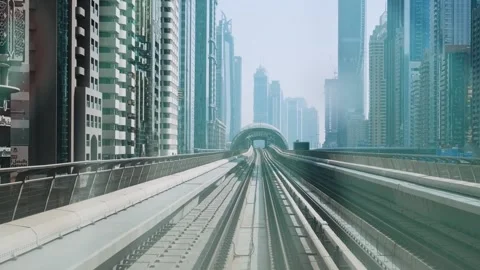 Dubai, UAE - May 5, 2024: Dubai POV monorail metro train passing through modern Stock Footage 288041761