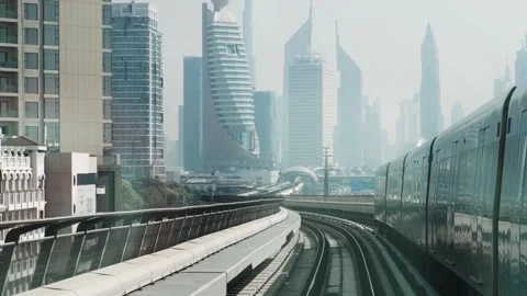 Dubai, UAE - May 5, 2024: Dubai tram passing through modern skyscrapers and Stock-Footage 288041780