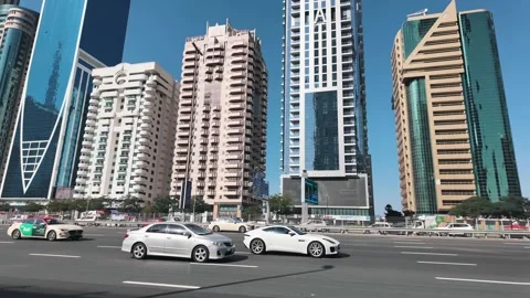 Dubai's Sheikh Zayed Road on a sunny morning, with traffic and towering Stock Footage 298307189