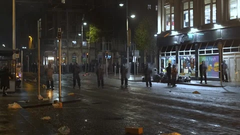 Dublin Riot 2023 - Protesters face off with police on Abbey Street at barricade Stock Footage 346332200