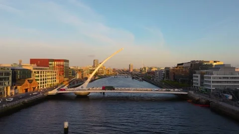 Dublin's Samuel Beckett Bridge at Dawn with Cityscape and River View Stock Footage 334327066