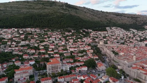 Dubrovnik old town red rooftops aerial below Mount Srd at dusk 動画素材 337572285