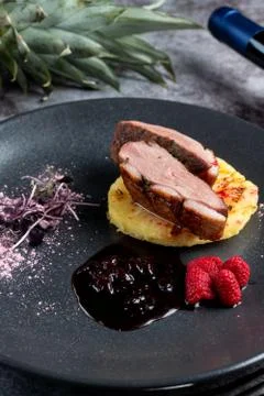 Duck breast with baked pineapple, raspberry and pomegranate sauce  delicatess Stock Photos