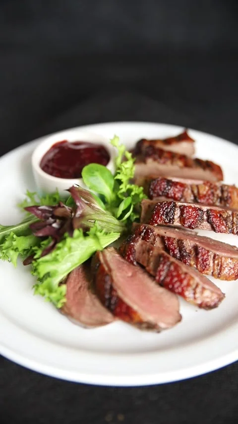 Duck breast slice roasted poultry meat main course tasty snack food Stock Footage 331295471