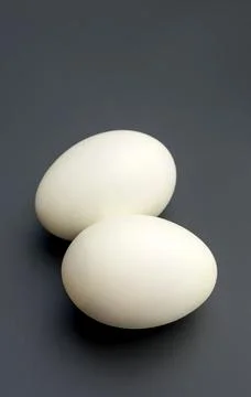 Duck eggs on a black background. Stock Photos