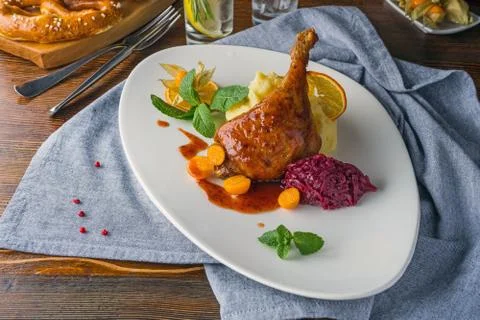 The duck leg on a rustic table in a cozy pub Stock-Fotos