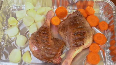 Duck leg with vegetables is prepared for baking. Stock Footage 254979046