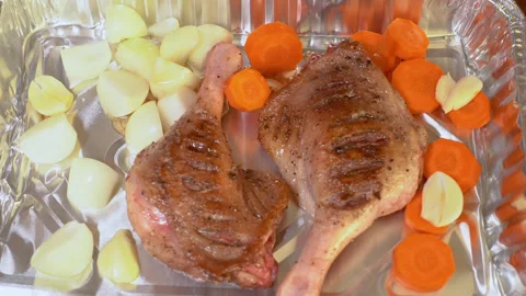 Duck leg with vegetables is prepared for baking. Stock Footage 254979374