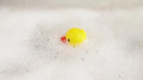 Duck toy in the bathroom, bath time buddy, floating duckling, bathtub fun Stock Footage 271663014