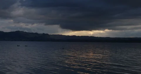 DUCKS IN FRONT OF SUN BEAM THROUGH CLOUDS 스톡 동영상 230992012