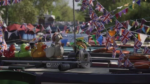 Ducks in a row on a barge - colourful.bunting behind Stock Footage 93200583