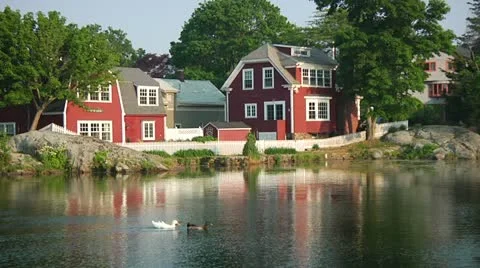 Ducks Swim in Pond in Front of Red House Stock Footage 12426271