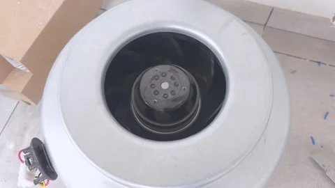 Duct fan with rotating impeller runs on the floor before installation Stock Footage 340644781