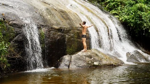 Dude jumping into water Stock Footage 94106931