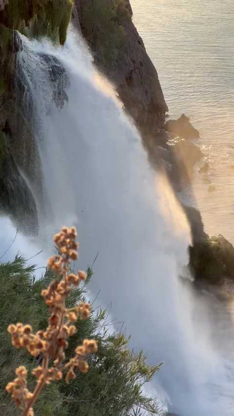Duden waterfall dropping in Mediterranean Sea  during sunrise Stock Footage 336996053