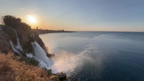 Duden waterfall dropping in Mediterranean Sea in Antalya, Turkey, during sunrise Stock Footage 336996522