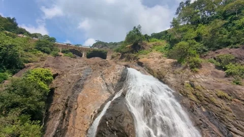 Dudhsagar waterfall. Train passes on bridge sounds horn. Goa. India. Video stock 260398929