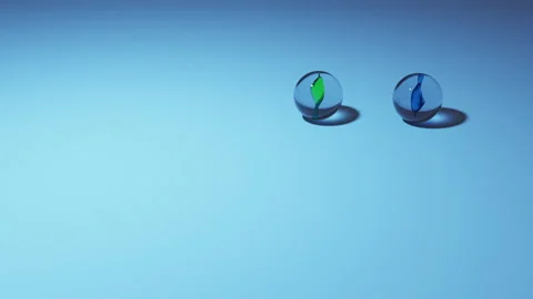 Duel marbles rolling on a bluish plain ground Stock Footage 220481002