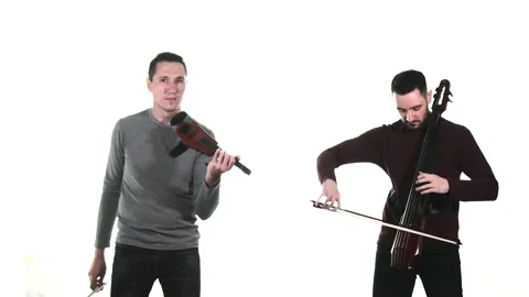 Duet of young talented men plays electric violin and electric cello. Isolated Stock Footage 134494822