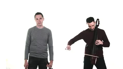 Duet of young talented men plays electric violin and electric cello. Isolated Stock Footage 134494872