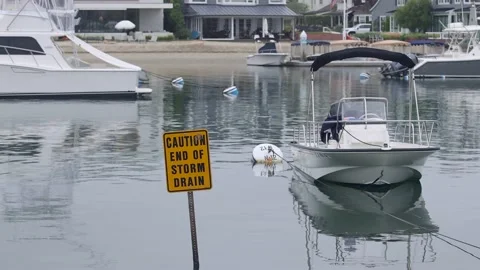 Duffy boat with Caution end of storm drain Stock Footage 232077775