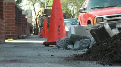 Dugup sidewalk with orange work cones and bulldozer city tree planting 2 Stock Footage 11024281