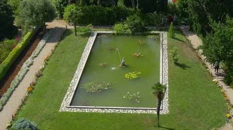 Duino castle garden pool with sculpture aerial view Stock-Footage 68345997