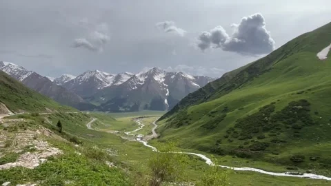 The Duku Highway (G217) winds dramatically through a vibrant, Stock Footage 342577277