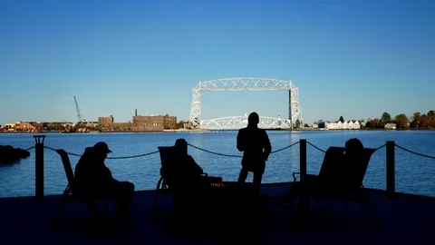 Duluth, MN - October 24, 2018: Friends enjoying a bonfire near lift bridge. Stock Footage 99381078