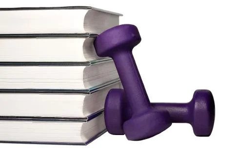 A dumbbell and stack of books for the concept of learning to be fit and healt Stock Photos