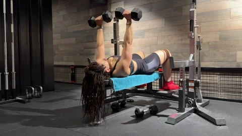 Dumbbell Bench Press with Reframing Shot – Woman Chest Workout in Gym Stock Footage 313102239