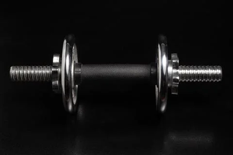 Dumbbell on Black Background Stock Photos