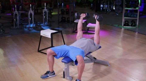 Dumbbell Fly on Workout Bench Stock Footage 32422561
