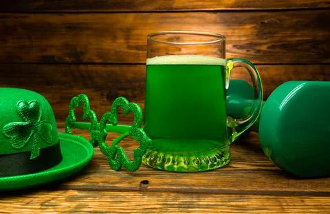 Dumbbell, green beer, hat with leaf clover, shamrock shaped glasses. Stock Photos
