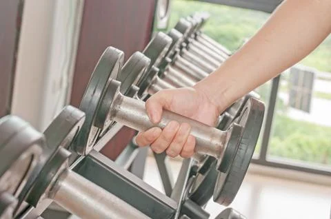 Dumbbell in hand Stock Photos