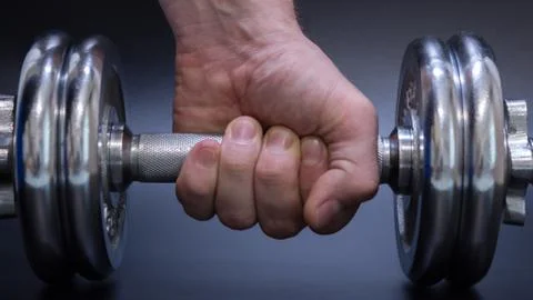 Dumbbell in hand Stock Photos