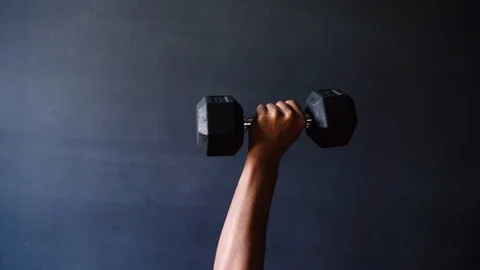 Dumbbell one-arm overhead press close up Stock Footage