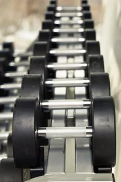 Dumbbell weights on a silver holder Stock Photos