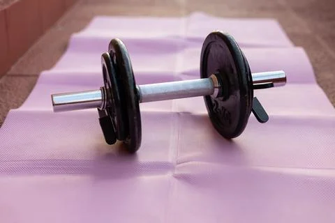 Dumbbell on yoga mat ready for home workout Fotos Stock