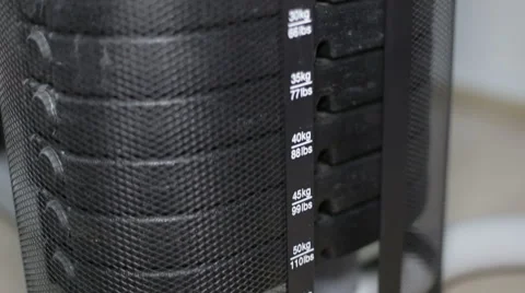 Dumbbells and weights weight trainer during training apparatus in the gym Stock Footage 63635015