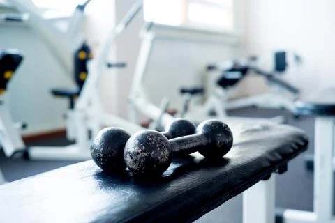 Dumbbells on a bench Stock Photos