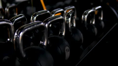 Dumbbells for bodybuilding in gym. Closeup of man's hands lifting weights in Stock-Footage 302102653