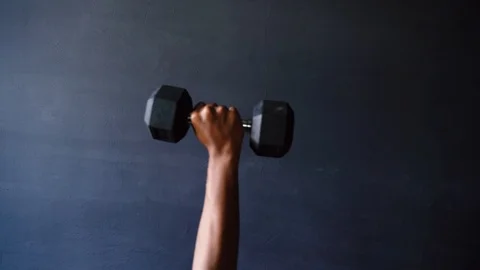 Dumbbells lifting exercise at gym Stock Footage 121443466
